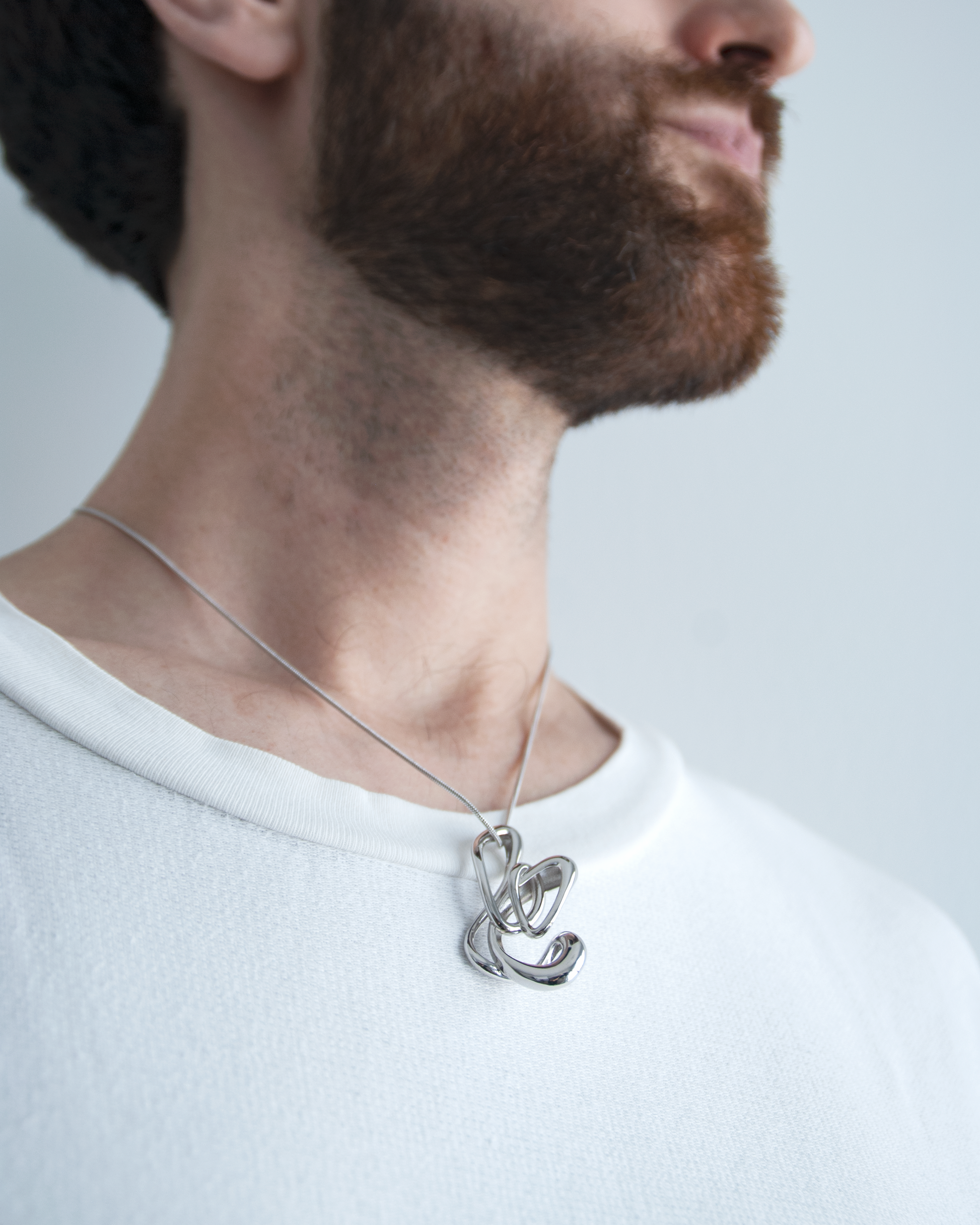 sculptural flicker pendant necklace, 2.5cm x 5cm – brass and rhodium jewellery by nood