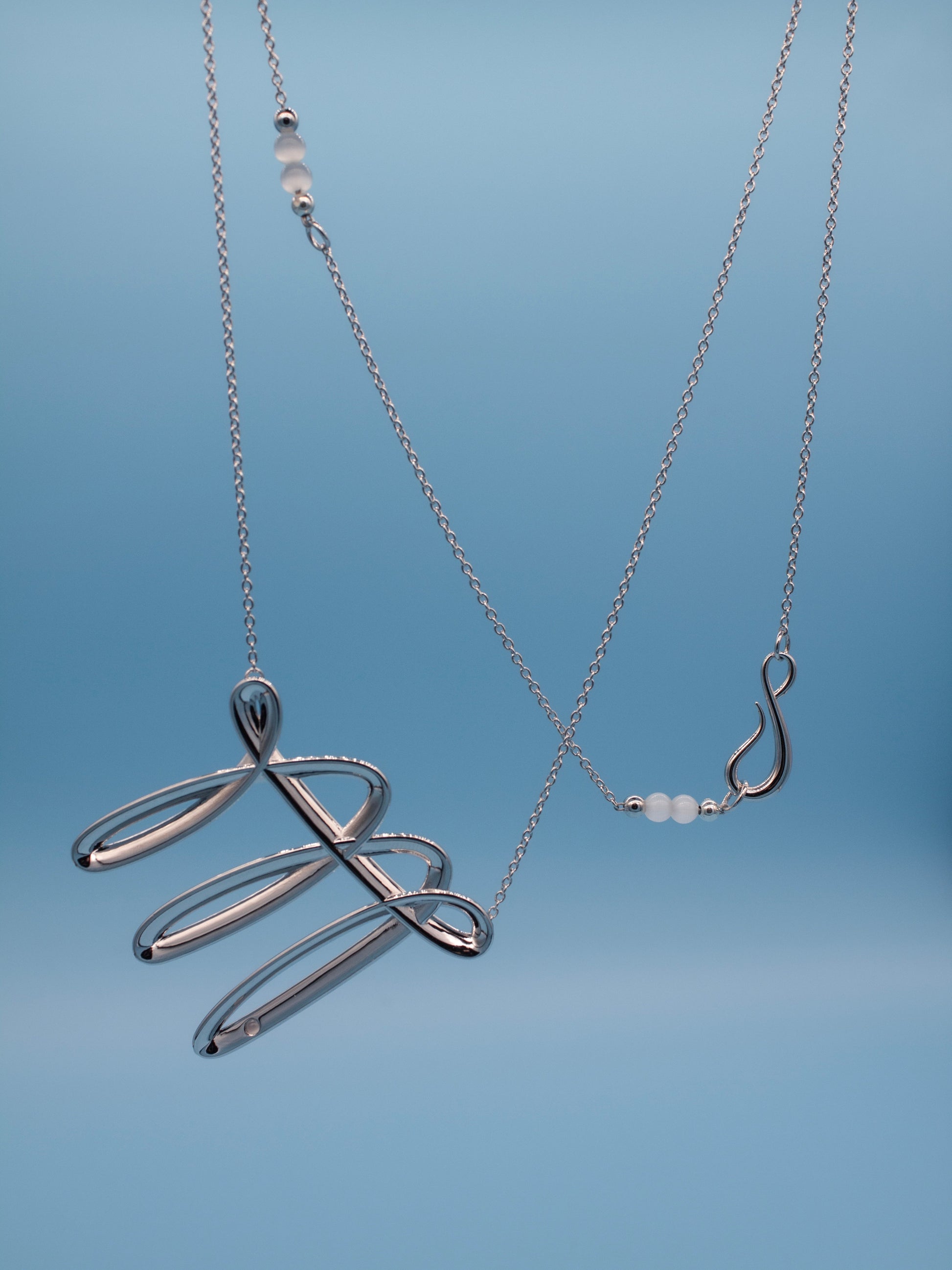 Long silver necklaces with fun stroke with a cat eye stone details