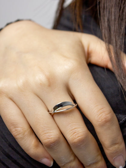 Close-up of nood Revisit Ring worn as a ring, highlighting its sculptural form and fluid metal surfaces
